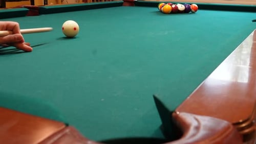 Person Breaks Pool Balls on 8 Ball Triangle Rack and makes the 2 Ball in the Corner Pocket Closeup o
