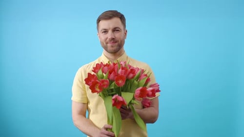 Handsome Man Presents Red Tulip Bouquet