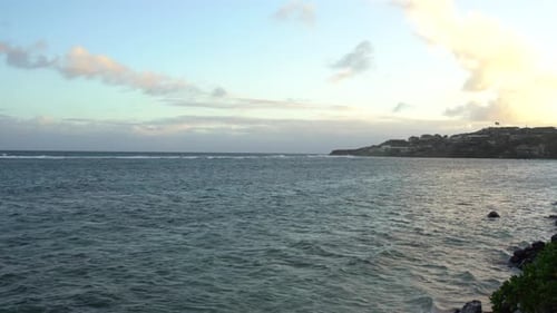 4K Ocean view at sunset time. Waves are breaking on the reef. Clouds gives stunning colours at the s
