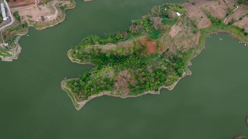 Drone view from top of forest land with green lake