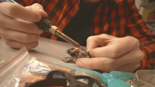 Close Up of Hands Soldering Electronic Component