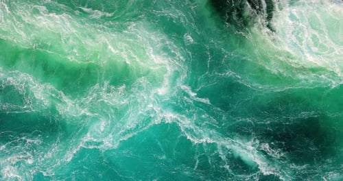 Blue waves of water of the river and the sea meet each other during high tide and low tide.