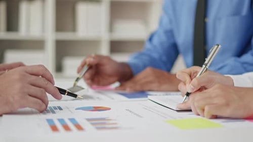 Close up of business hands are working and brainstorming on paperworks.