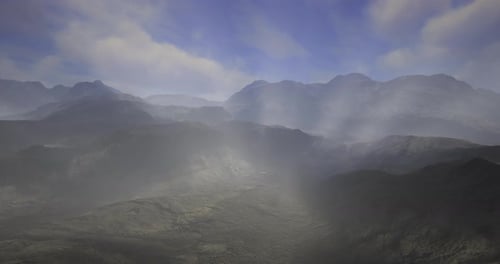 Misty Mountain Landscape During Early Morning Light with Clouds Above