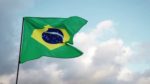Brazilian Flag Waving Against Cloudy Sky