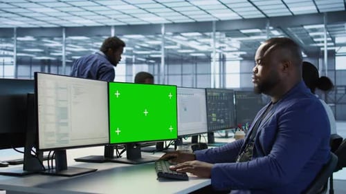 Engineer Using Green Screen Computer Working in Server Farm