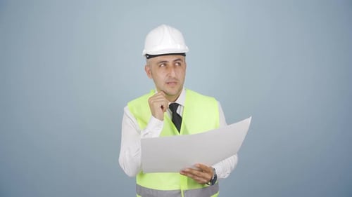 Engineer looking at camera and making positive gesture.