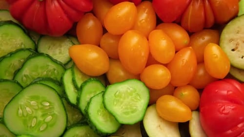 Sliced Fresh Vegetables: Cucumbers, Tomatoes, and Eggplant