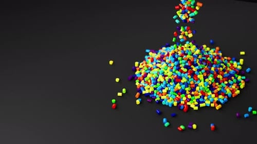 Colorful Plastic Polypropylene Granules Pouring From Cup on a Pile of Granules Masterbatch Polymer