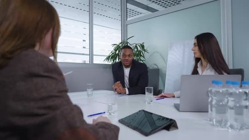 Diverse Team Discussing Business at Conference Table