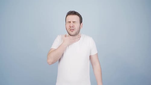 Man with Sore Throat Rubbing his Neck