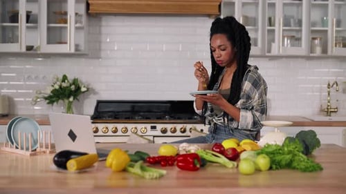 Woman Enjoys Healthy Snack in Bright Kitchen