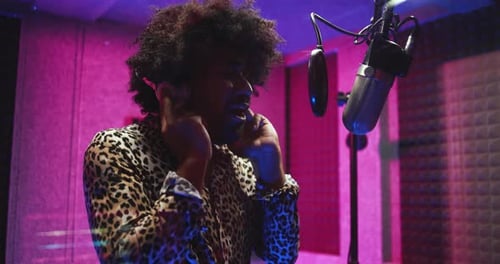 African american singer recording new music album at recording studio in USA