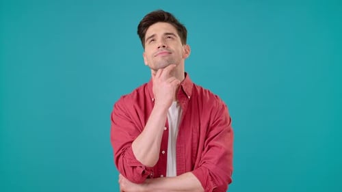Thoughtful Young Man Thinking on Blue Background