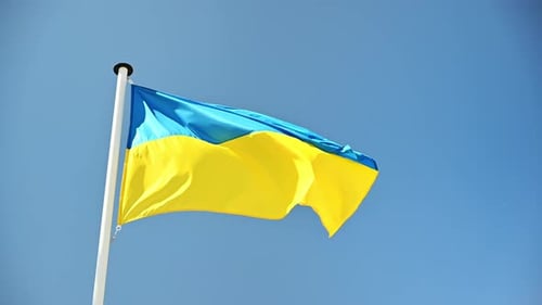 Ukrainian Flag Waving Against Blue Sky