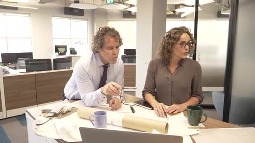 Business colleagues discuss strategy and plans in a modern office setting