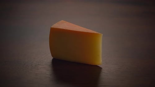 Cheese Wedge on Dark Wooden Surface