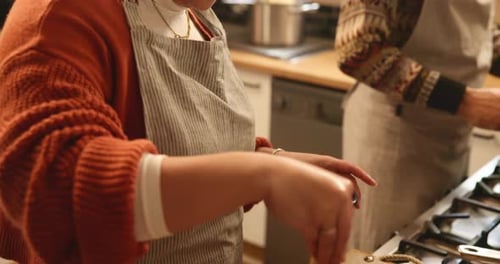 Woman Seasoning Chicken in Bright Kitchen
