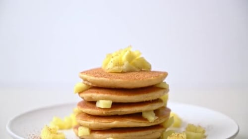 Pancake Stack Topped with Apples on White Plate