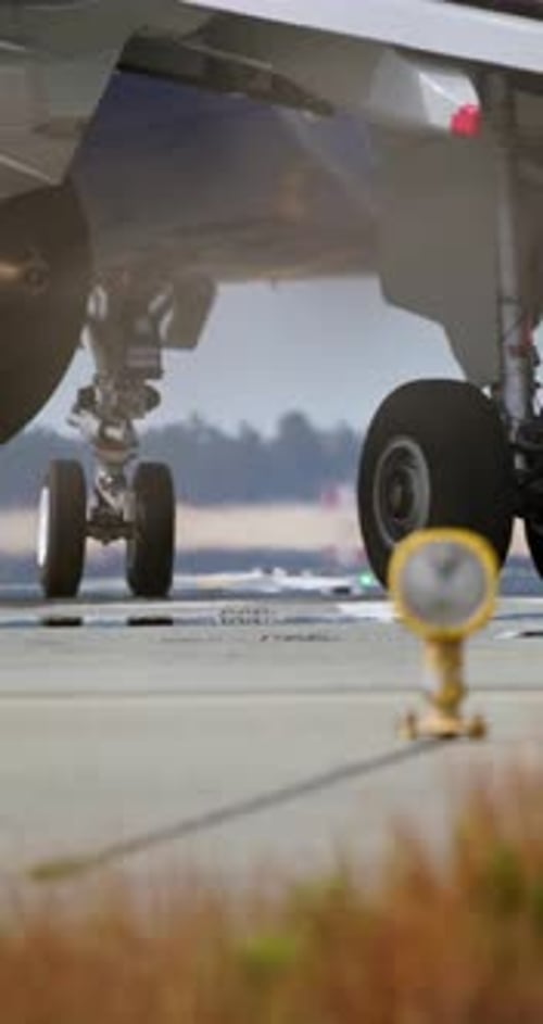 Closeup of Aircraft Wheels As They Meet Runway