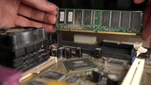 Man Repairs and installs Computer Ram Memory close up