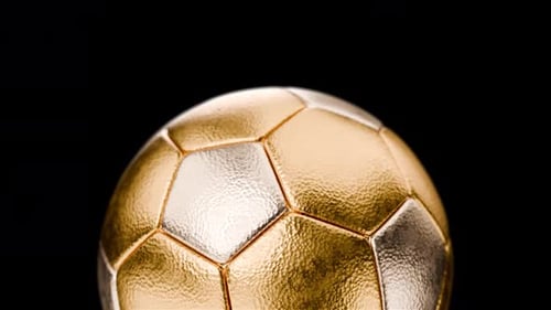 Rotating Golden and Silver Metallic Soccer Ball on Black Background