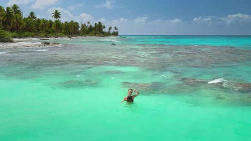 Woman Swims in Tropical Turquoise Ocean Water