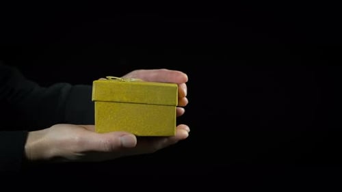 Hands Opening Sparkling Gift Box