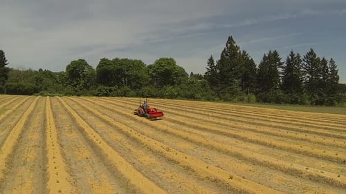 Aerial of Man Driving Tractor on Farm