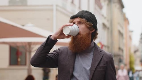 Young Man Enjoying Drinking Morning Coffee Hot Drink Relaxing Taking a Break in City Street