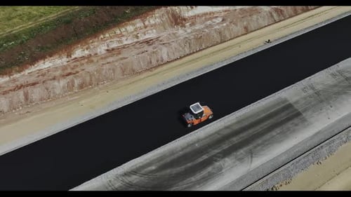 Road Roller Drives on Newly Paved Asphalt