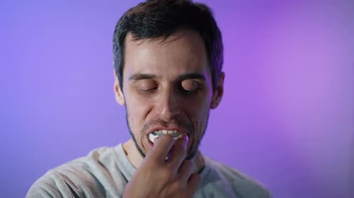 Man Uses Light Up Teeth Whitening Device
