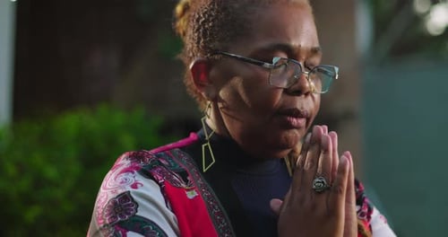 Woman Praying Peacefully in Garden