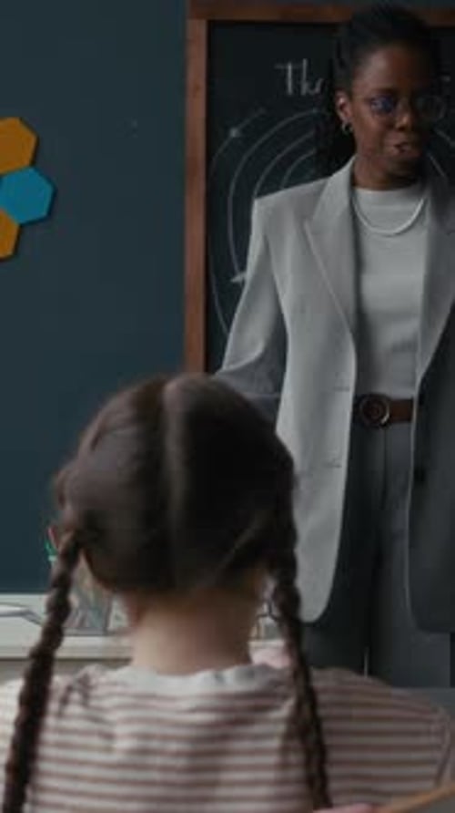 Teacher Smiling in Classroom with Student