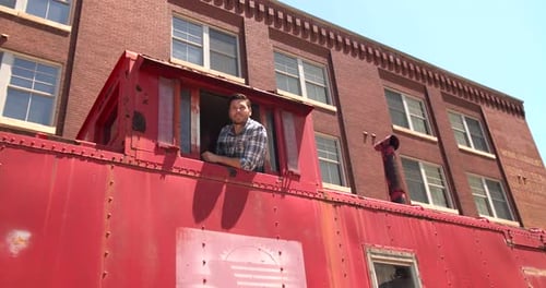 Man leaning out of vintage santa fe train at wichita Kansas transportation museum