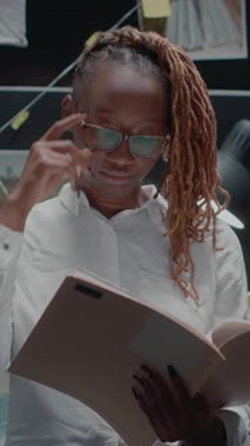 Stressed Woman Reviews Documents in Vertical Video