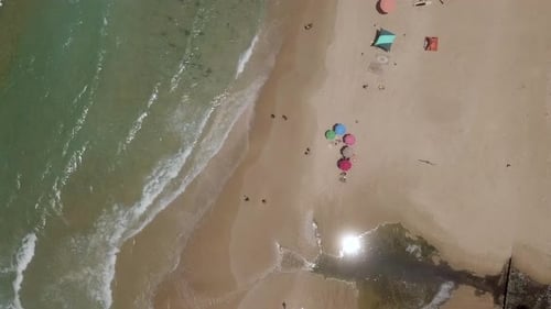 Summertime in a public Beach with colorful umbrellas
