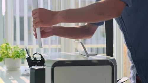 Office Manager Putting Paper to Printer Preparing for Conference