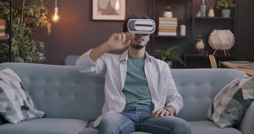 Young Adult Using Virtual Reality Headset at Home