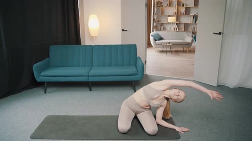 Woman Kneeling on Mat Stretching Arms