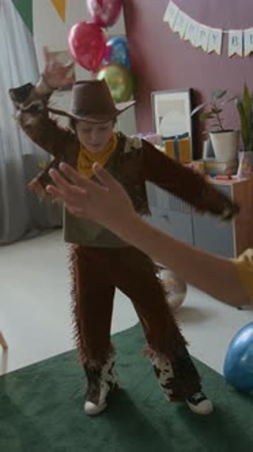 Boy in Cowboy Outfit Dancing with Other Kids During Birthday Celebration at Home