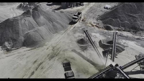 Truck Maneuvers Through Sandy Quarry at Construction Site
