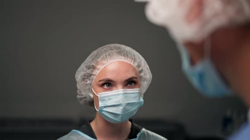Close Up in a Modern Clinic in a Bright Spacious Operating Room a Doctor Surgeon in Sterile Gloves
