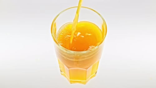 Orange Juice Pouring Into Glass
