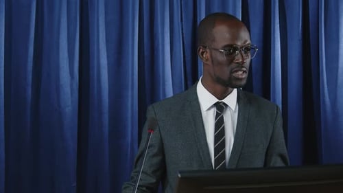 Man Speaking at a Podium at Corporate Event
