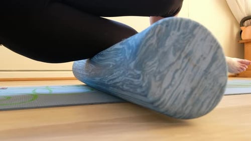 thirty something female doing core strength exercise in a home gym