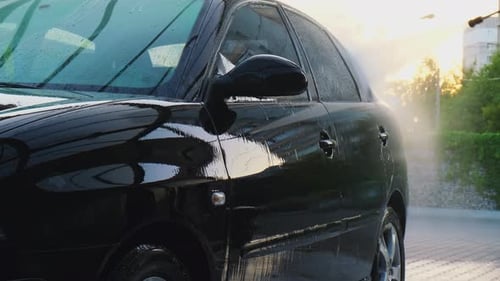 Washing Luxury Black Car on Touchless Car Wash Cleaning the Details of Car Washing Sedan Car with