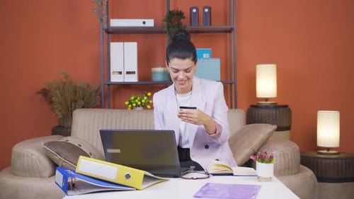 Home office worker young woman doing online shopping.