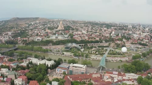 Aerial view of Tbilisi city center, Rike park and concert hall and Bridge of peace over Kura river.