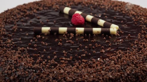 Rotating Chocolate Cake Decorated with Raspberry and Chocolate